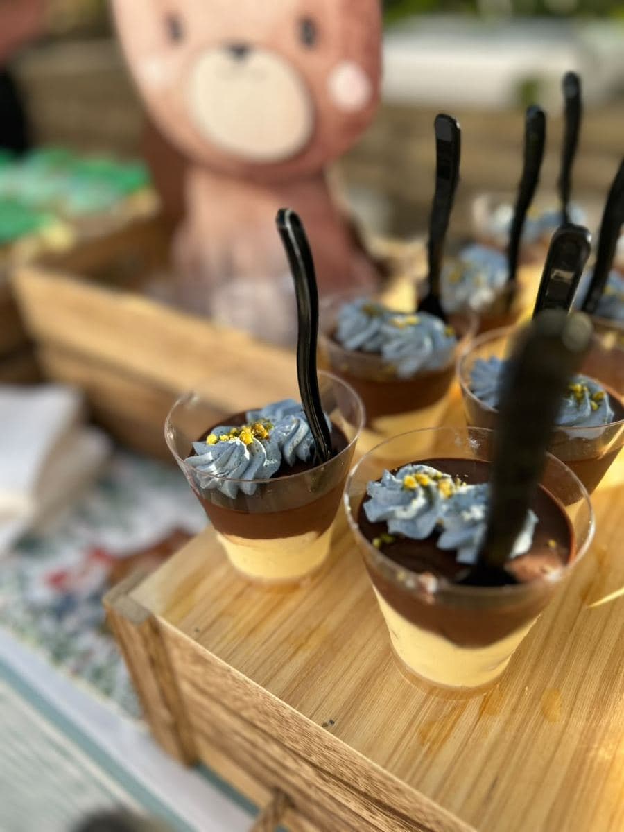 Two-layer mousse cup with blue cream and crushed pistachio