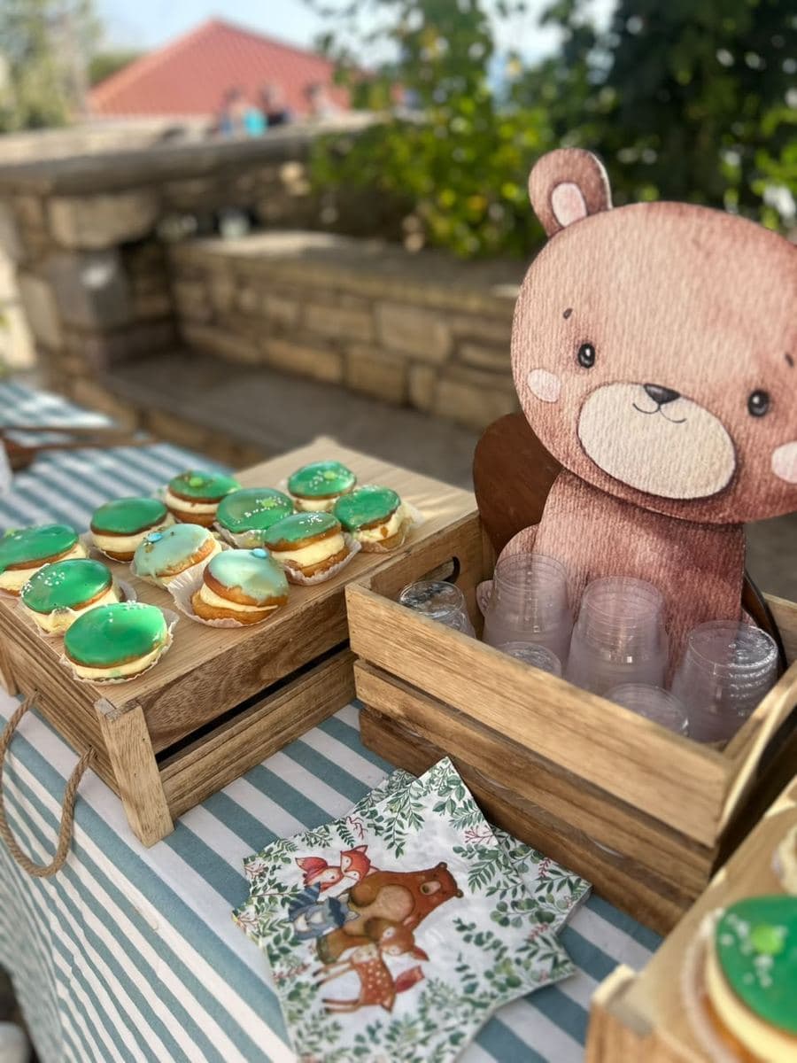 Dessert table at a woodland-themed christening on a stone terrace