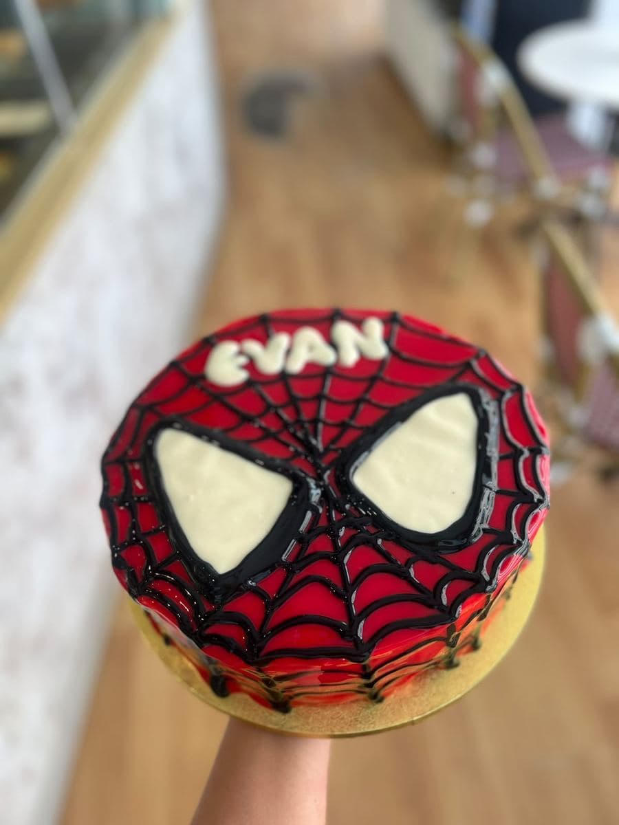 Childrens superhero birthday cake in red and black