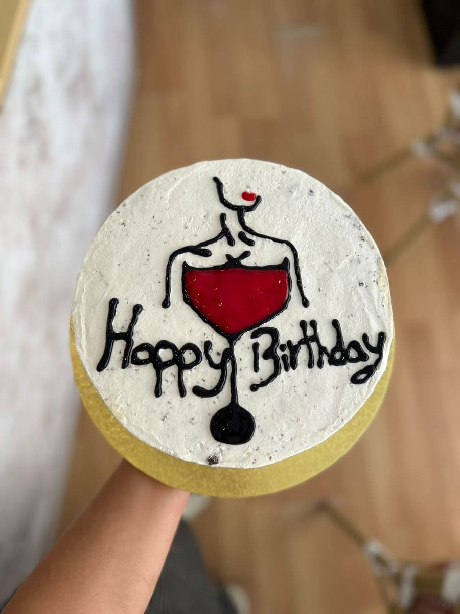 Birthday cake with a hand-piped wine glass